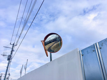 Low angle view of ferris wheel against sky