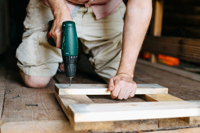 Midsection of man working at workshop