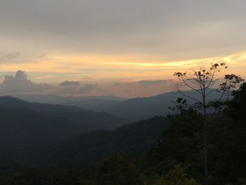 Scenic view of silhouette mountains against sky at sunset