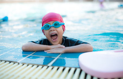 Portrait of girl leaning on poolside