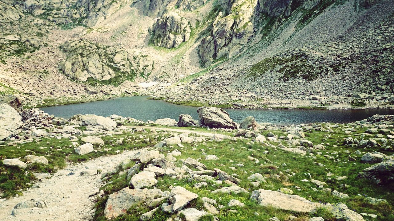 water, rock - object, tranquility, tranquil scene, nature, rock, beauty in nature, scenics, rock formation, high angle view, plant, day, river, stone, non-urban scene, lake, mountain, stone - object, tree, idyllic