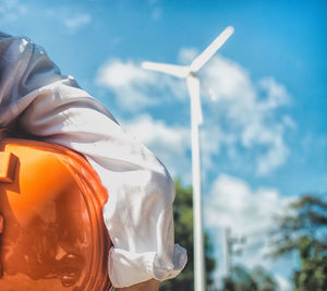 Low angle view of windmill against sky