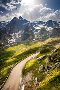 Scenic view of road amidst mountains against sky