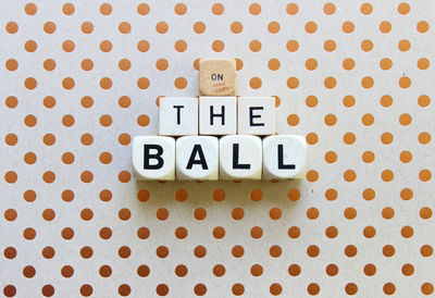 Directly above shot of on the ball text made from dice