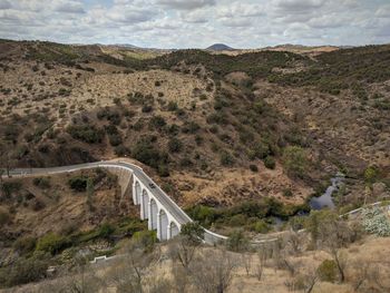 View of bridge over land against sky