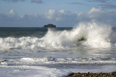 Waves breaking against sea