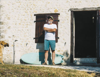 Portrait of young man standing against wall