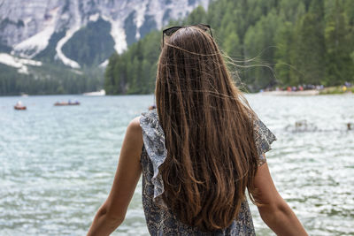 Rear view of woman standing in water