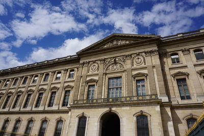 Low angle view of historical building against cloudy sky