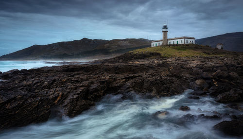 Lariño lighthouse on a winter sunset. carnota, galicia, spain.