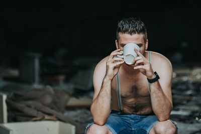 Portrait of young man sitting outdoors