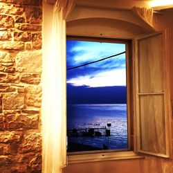 Scenic view of sea seen through building window