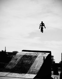 Low angle view of man jumping on building