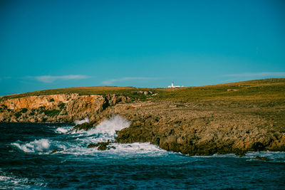 Scenic view of sea against clear blue sky