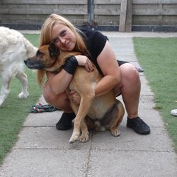 Portrait of smiling woman with dogs outdoors