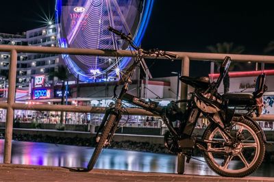 Bicycle on bridge in city at night