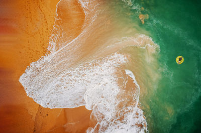 High angle view of surf on beach