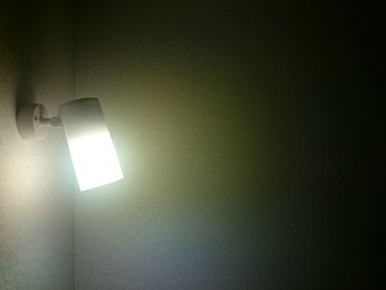 Close-up of illuminated electric lamp in room