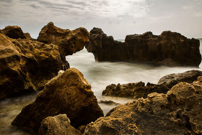 Scenic view of rock formations on coast