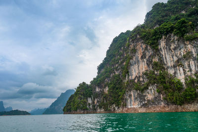 Scenic view of sea and mountains against sky