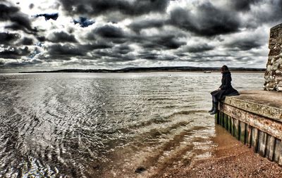 Scenic view of sea against cloudy sky