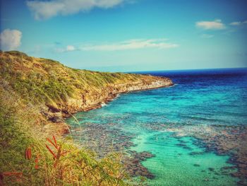 Scenic view of sea against blue sky