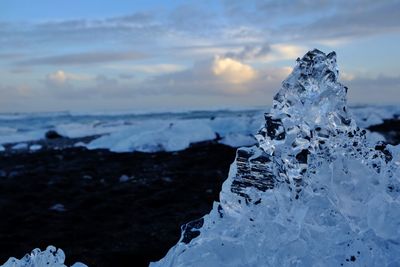 Frozen sea against sky