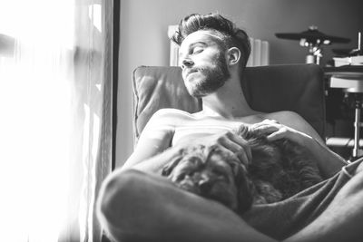 Rear view of two people sitting on tiled floor