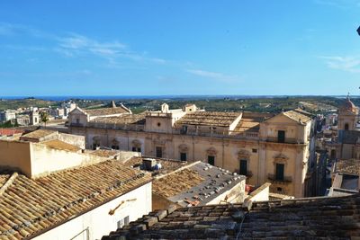 View of cityscape against blue sky