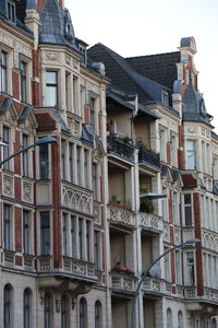 Low angle view of buildings in town against sky