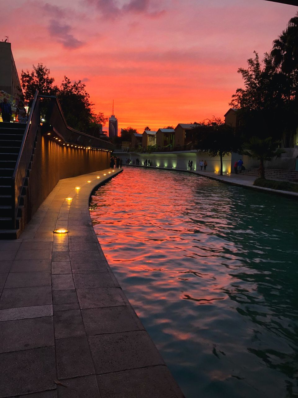 VIEW OF BRIDGE OVER RIVER AT SUNSET