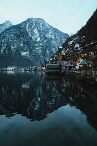 Houses by lake against mountain