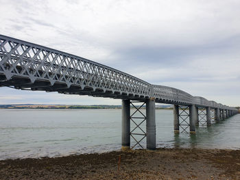 Bridge over sea against sky