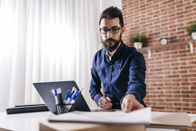 Businessman working at table in office