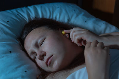 Close-up of baby sleeping on bed