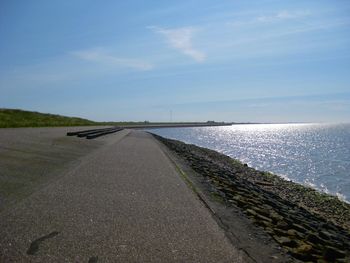 Road by sea against sky