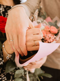 Midsection of woman holding bouquet