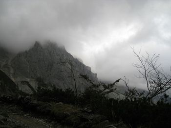 Scenic view of mountains against cloudy sky