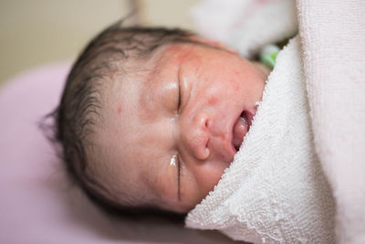 Close-up high angle view of baby boy sleeping