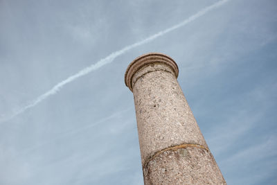 Low angle view of smoke stack against sky