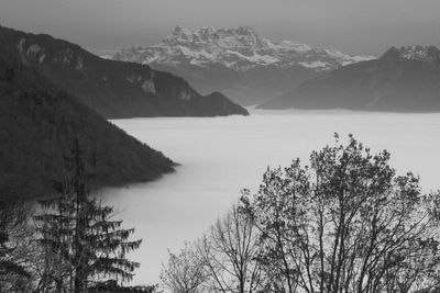 Scenic view of mountains against cloudy sky