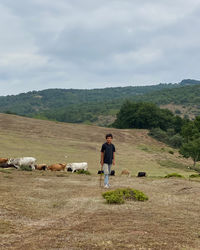 Full length of man standing on mountain against sky