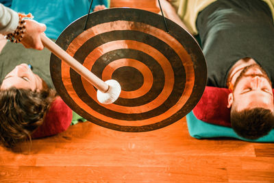 Therapist playing equipment while performing music therapy at spa