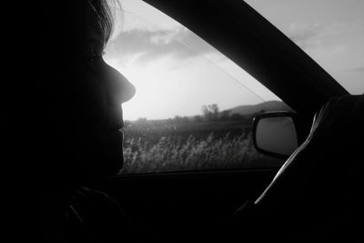 Close-up of car against sky seen through window