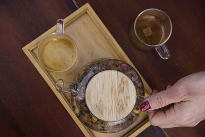 Cropped hand of person preparing food on table