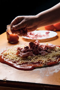 Preparing pizza base at home, we put tomato, cheese,...