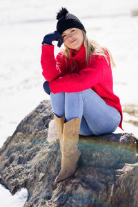 Young woman sitting on rock