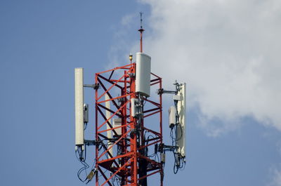 Low angle view of communications tower against sky