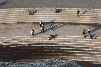 High angle view of people walking on staircase