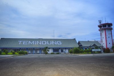Road by building against sky in city
